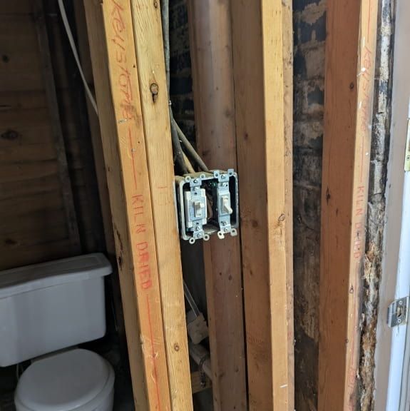 Two switches installed in a metal electrical box during residential remodeling in Oak Ridge NC