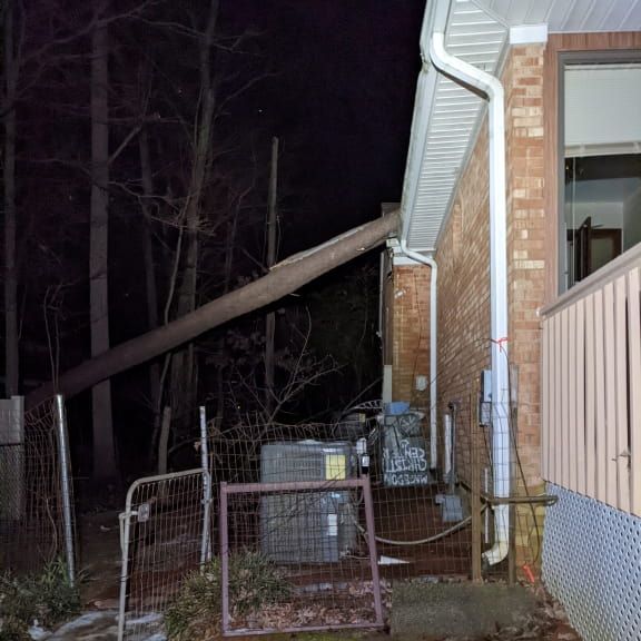 Emergency electrician assessing storm damage