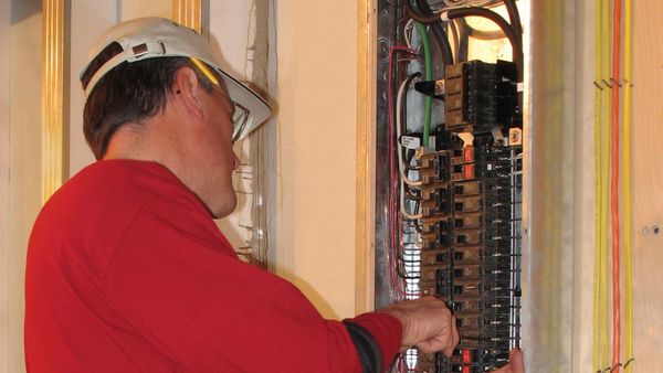 electrician working on electrical panel