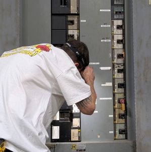 Licensed Commercial Electrician Inspecting Distribution Panel