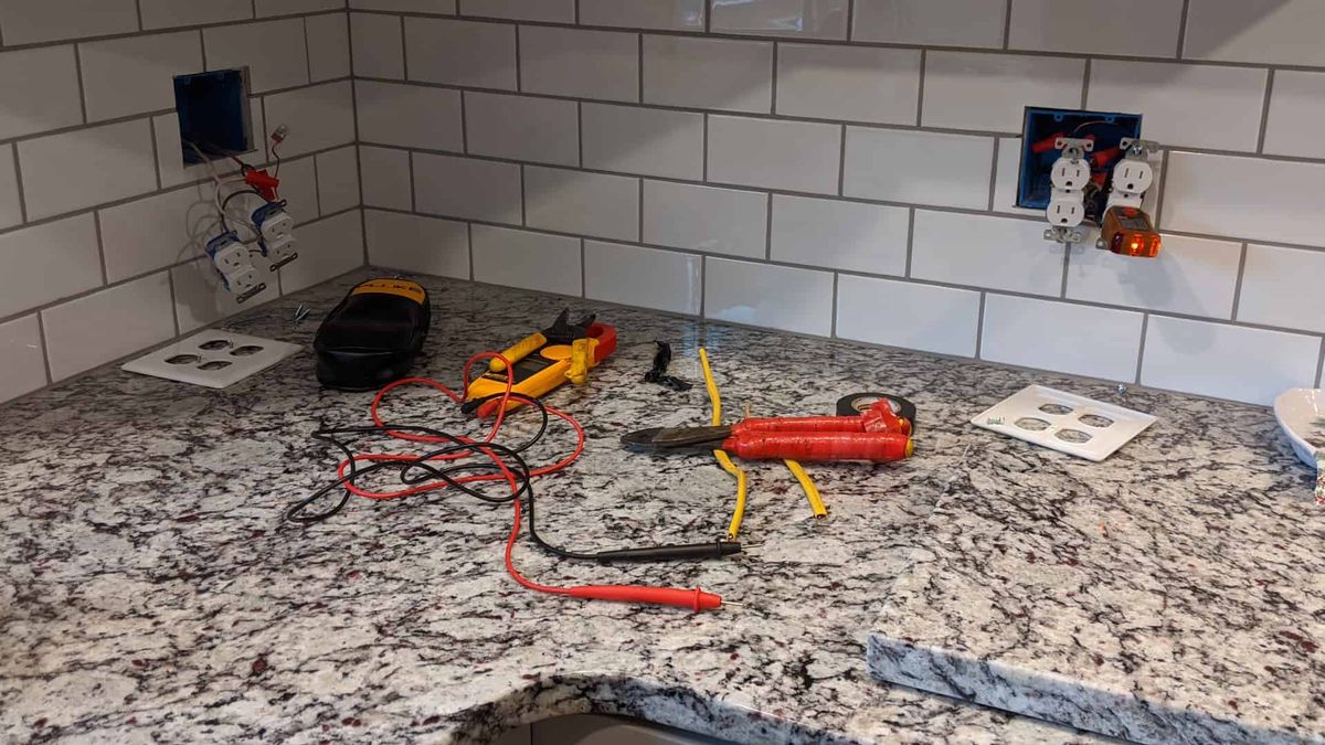 Kitchen outlet troubleshooting with electrical testing tools