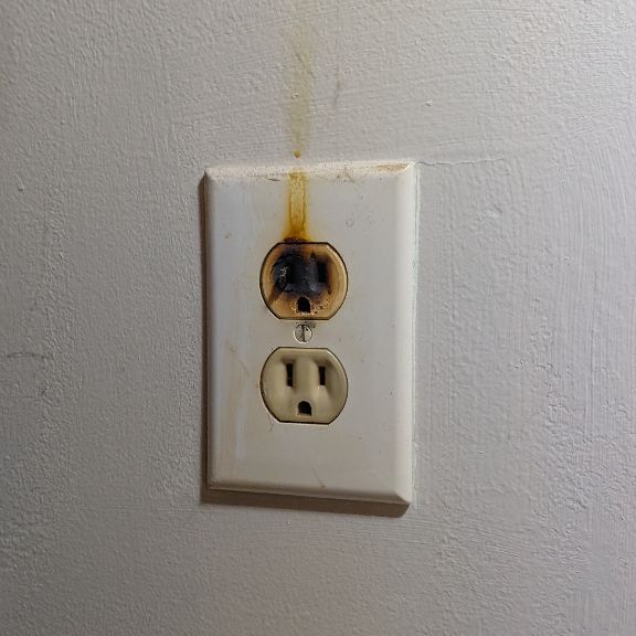 Burnt Electrical Outlet With Visible Heat Damage