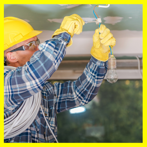 Electrician installing a light bulb