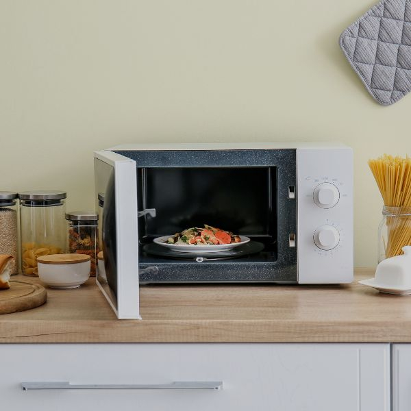 A microwave with a plate of food inside