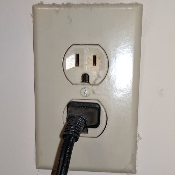 Electrical outlet showing early warning sign discoloration