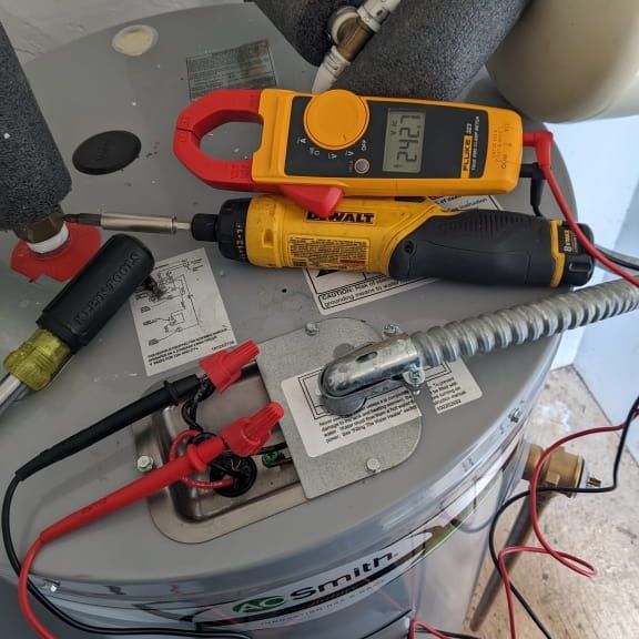 Electrician testing voltage at residential electric water heater in Reidsville NC
