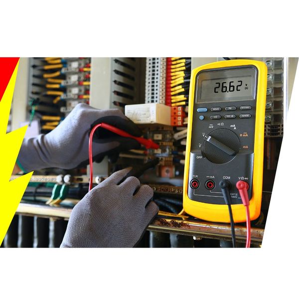 Electrician using a multimeter at an electrical panel