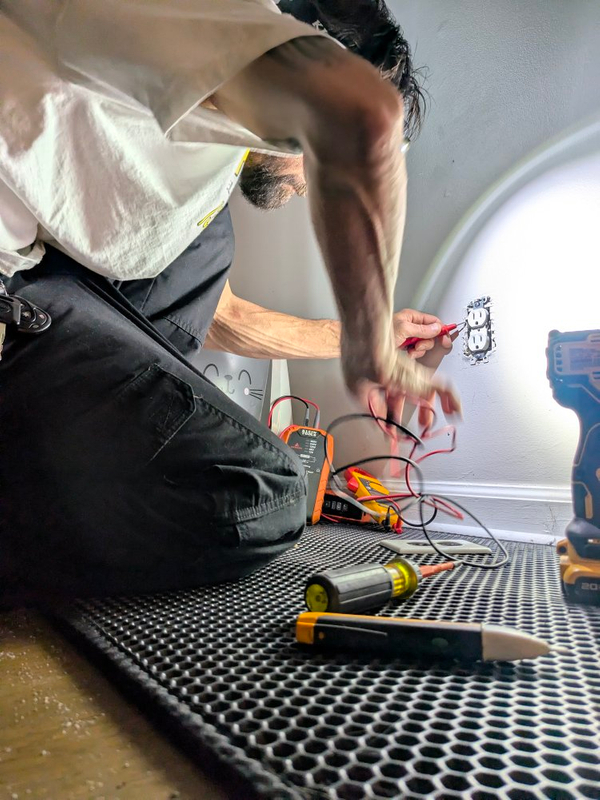 Power Restored Greensboro NC. Electrician Testing Receptacle Voltage