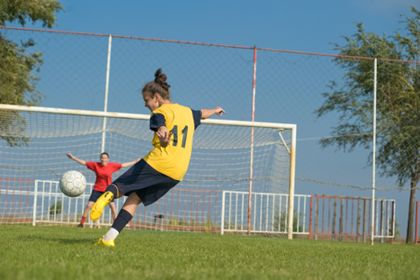 girl finishing volley w partner...jpg