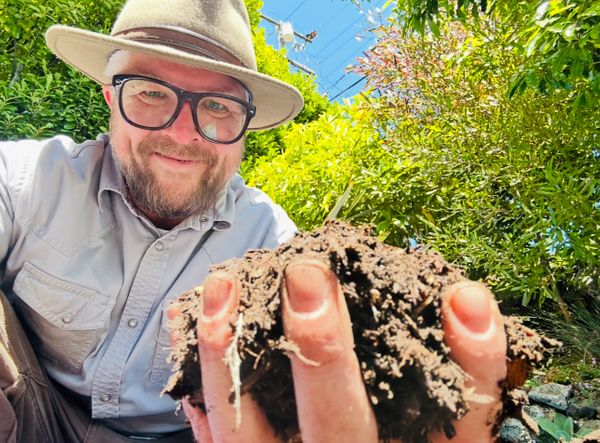 Kirt loving on the soil Installation lead.jpeg