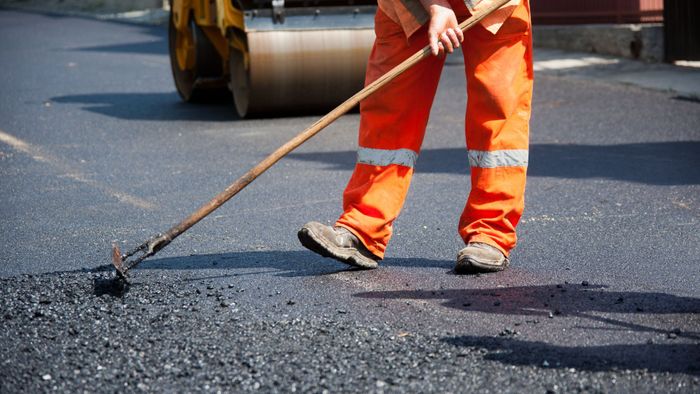 worker paving asphalt