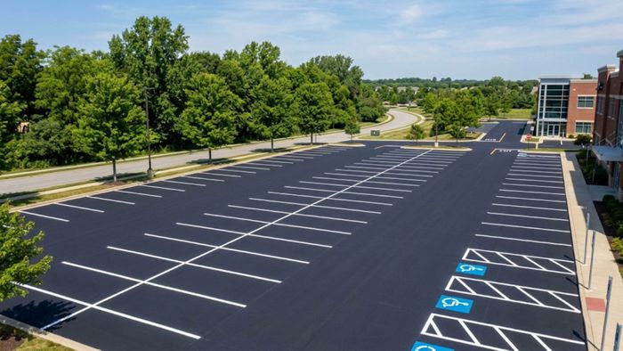 Freshly paved commercial asphalt parking lot by Ace Asphalt Paving in Hattiesburg, MS.