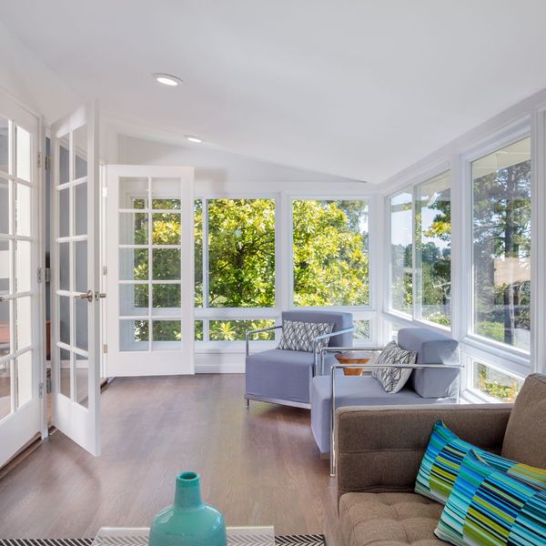 an enclosed sun room with outdoor furniture