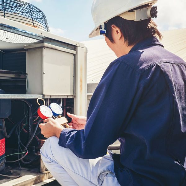 HVAC technician performing maintenance on a unit Emergency HVAC Repairs4.jpg