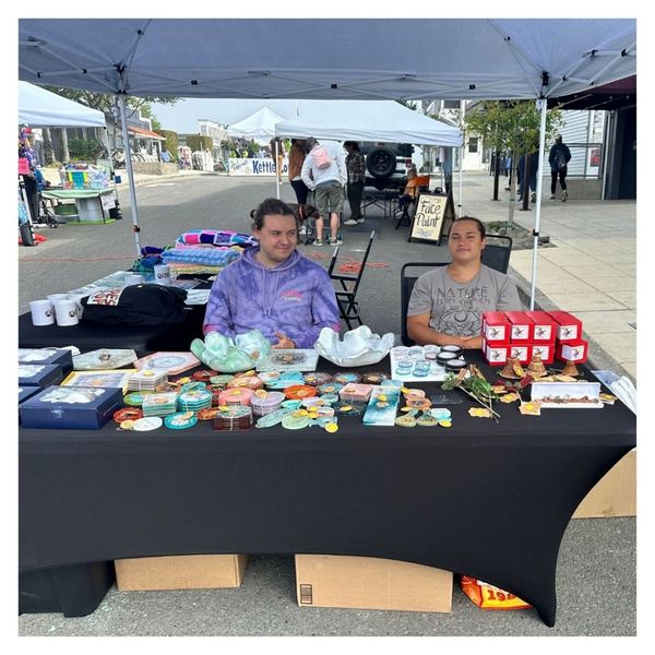 artist selling wares at market