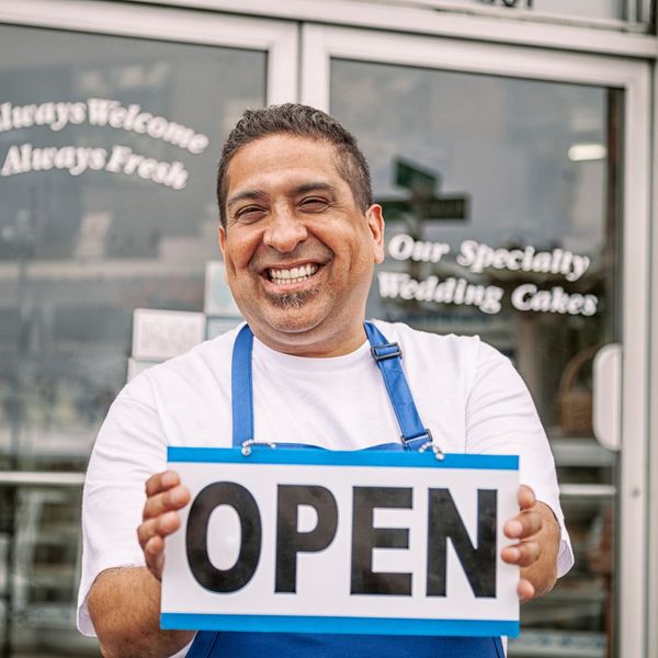 business owner in front of wedding cake shop