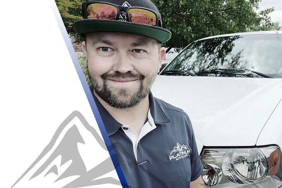 photo of a Platinum Auto Tech standing next to a repaired windshield