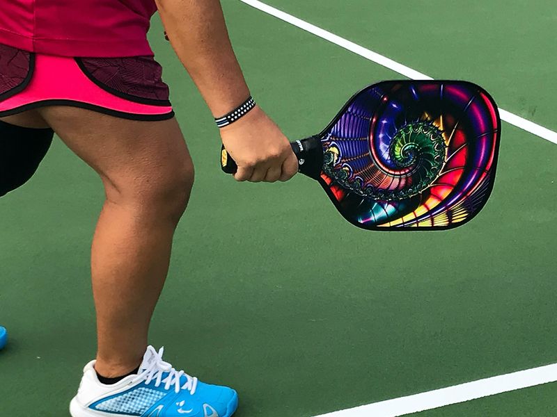 close up of woman holding pickleball paddle