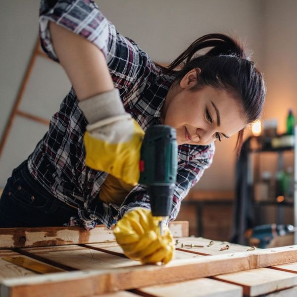 a woman using power tools on a project