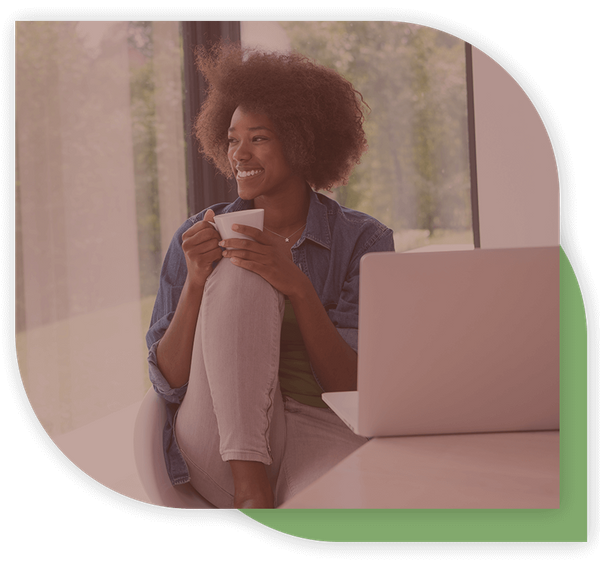 woman sitting and smiling with her tea