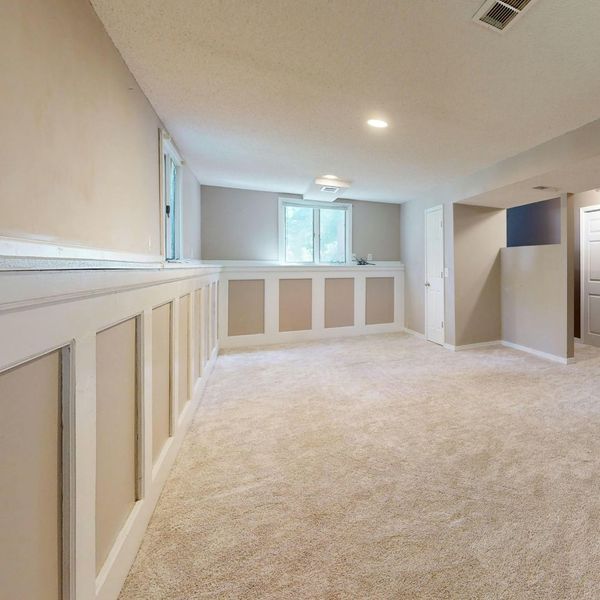 An empty, finished basement with board and batten