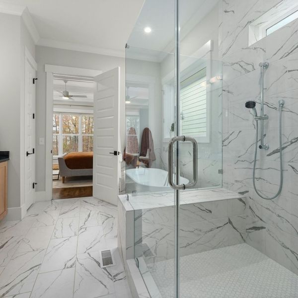 A newly remodeled bathroom with granite floors and shower