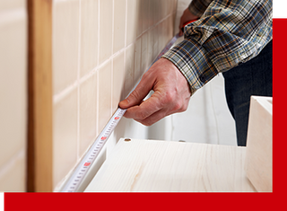 Contractor measuring a room in a home