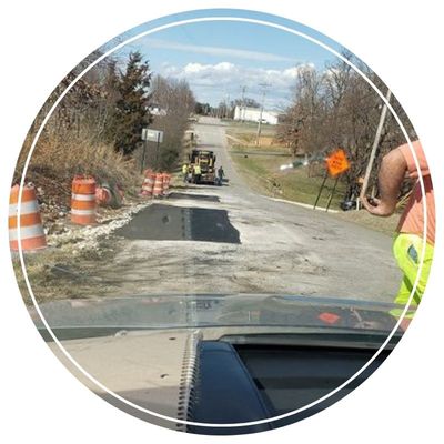 Road repair in progress, orange cones visible