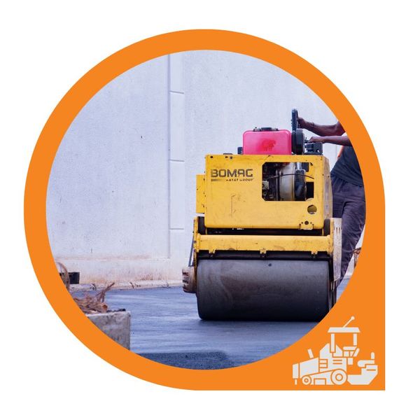 An asphalt contractor using a paving machine on a asphalt road