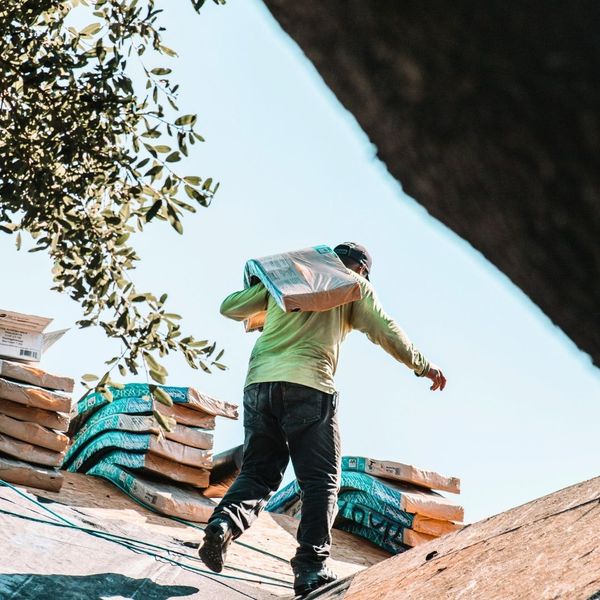 roofer carrying shingles