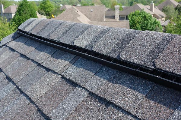 Close-up of a ridge vent system installed on a shingle roof, showing proper attic ventilation.