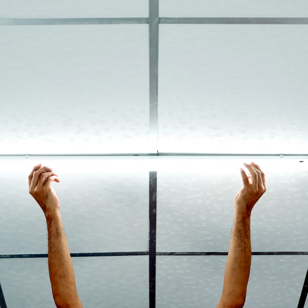Hands Working on a Commercial Drop Ceiling LED Light Fixture