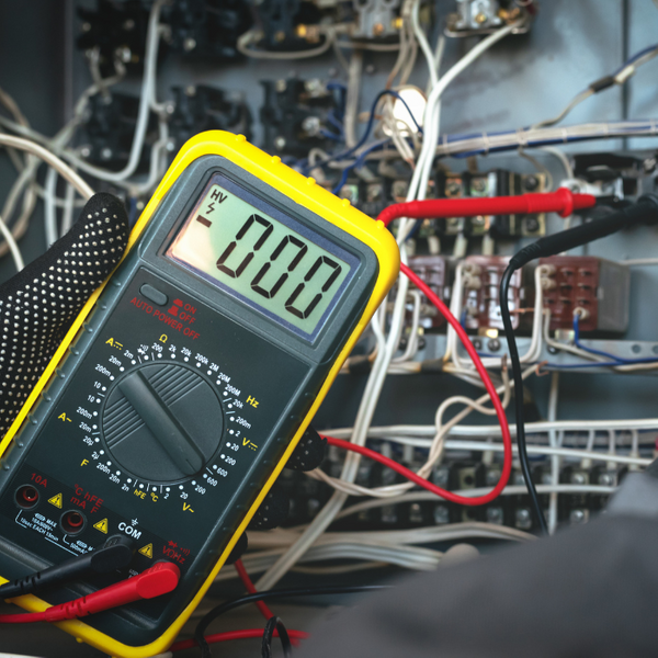 Electrician Troubleshooting with a Digital Multimeter