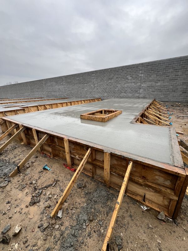 Freshly Poured Concrete Foundation Slab with Formwork