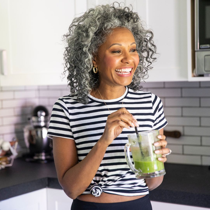 Fit mature person drinking a green smoothie