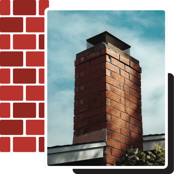 A low-angle photograph looking up at a red brick chimney with a metal mesh spark arrestor cap against a blue sky with light clouds.