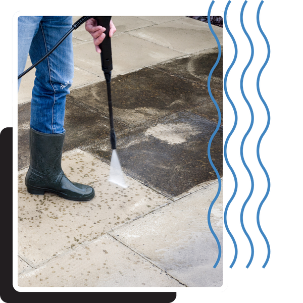 someone pressure washing a concrete surface