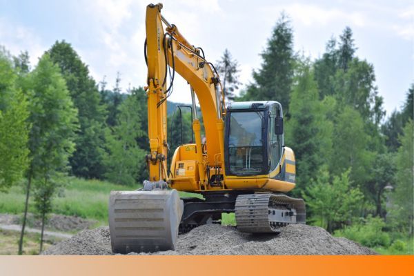 an excavator on a pile of dirt Home.jpg