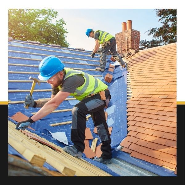 roofers repairing roof