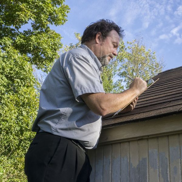 roofer inspecting a roof