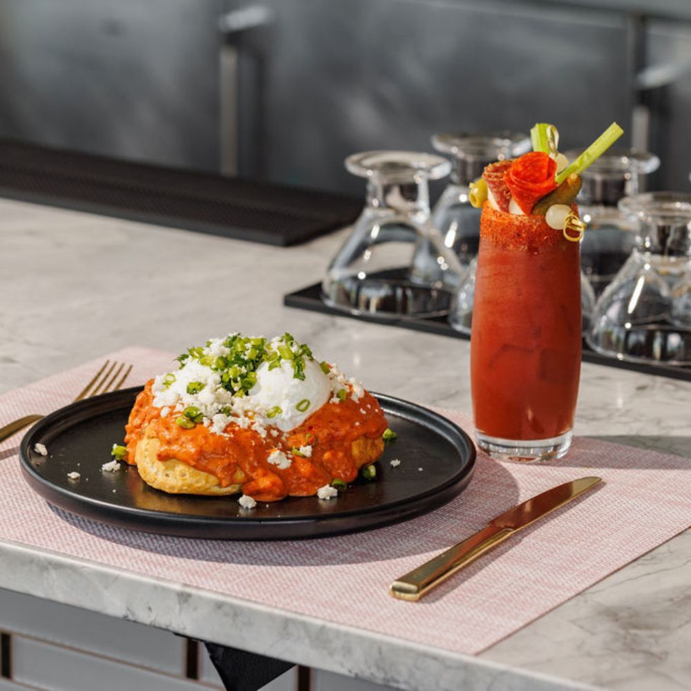 a plate of food and a cocktail on a set bar counter