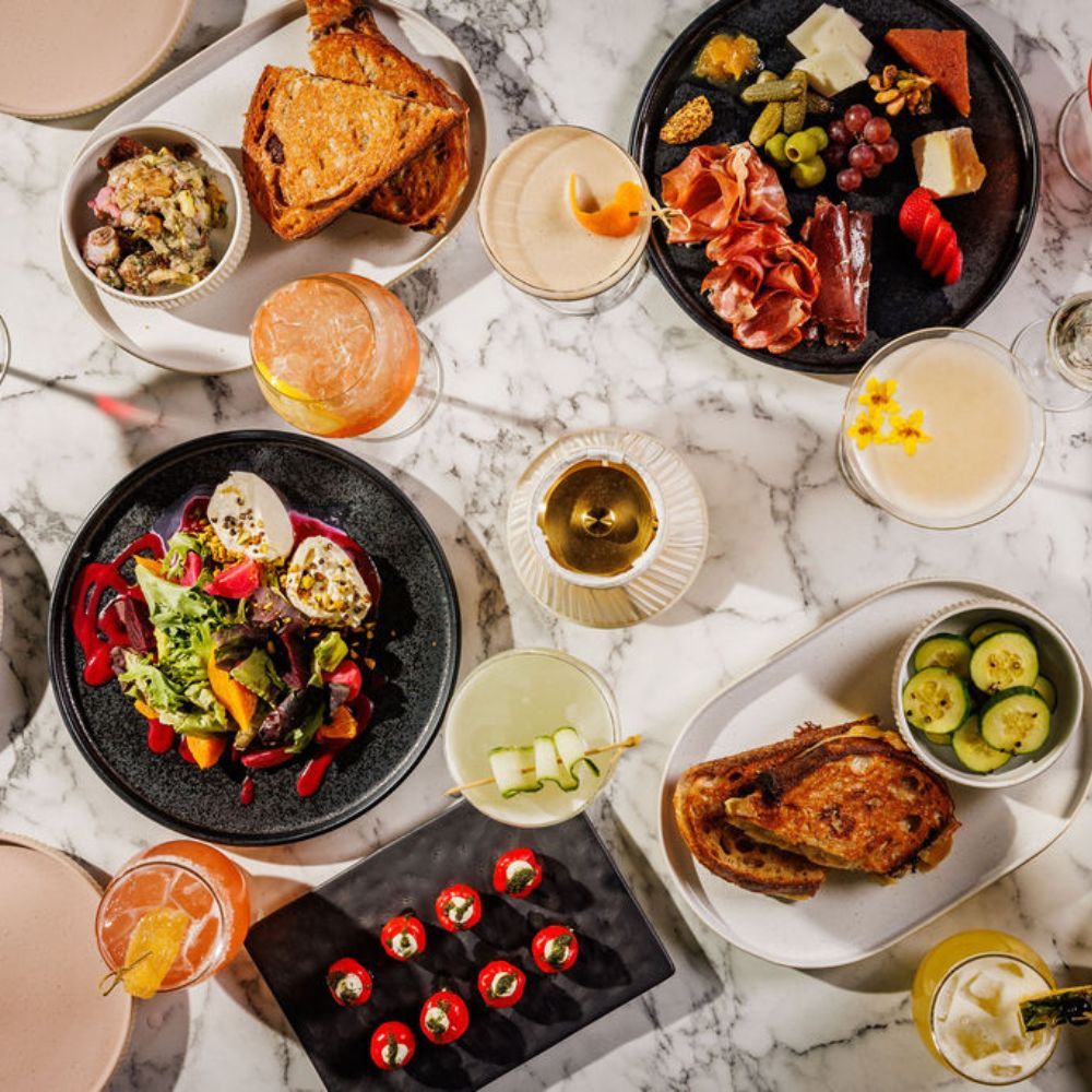 plates of food and cocktails on a table