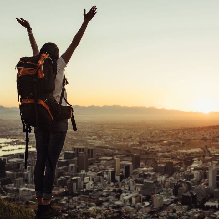 Happy backpacker at sunset 