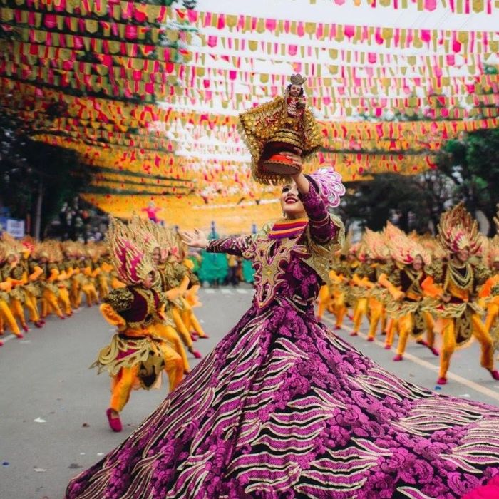 woman dancing in colorful dress at festival