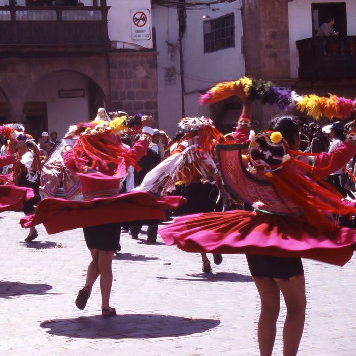 people in colorful dress dancing a festival