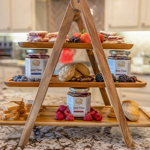 jam vino jars displayed with fruits and pastries