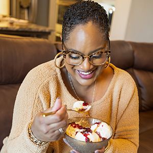 Chef Lorious eating ice cream with jam vino on top