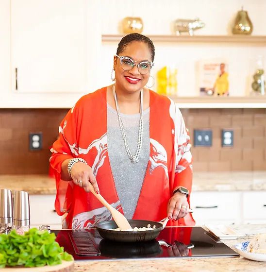 Chef Lorious cooking at a stove