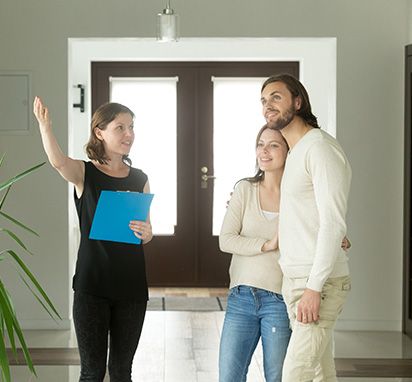 Image of a realtor showing a house
