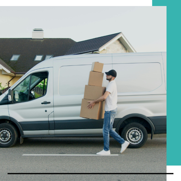 mover carrying boxes outside moving van